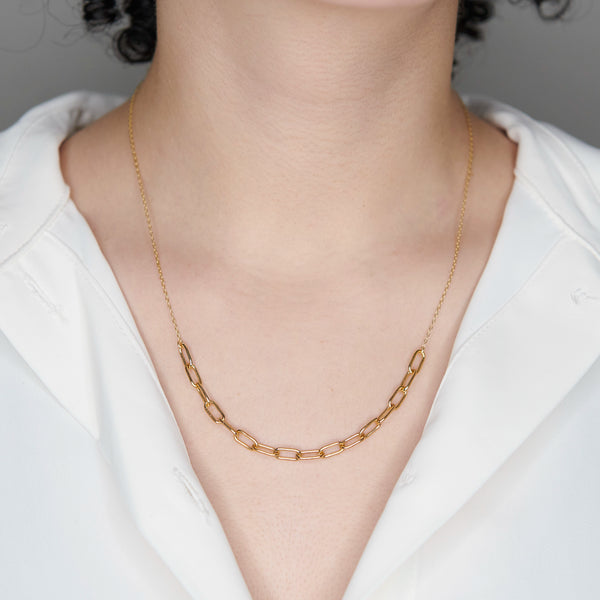 A woman wearing an ANI Textured Link Necklace