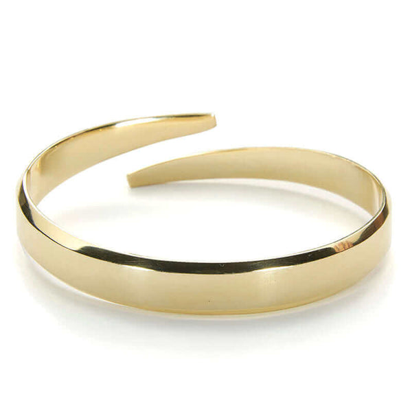 Heavy cuff bracelet with chamfered edges and overlapping ends, in polished brass.