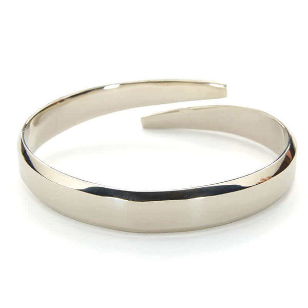 Heavy cuff bracelet with chamfered edges and overlapping ends, in polished white bronze.