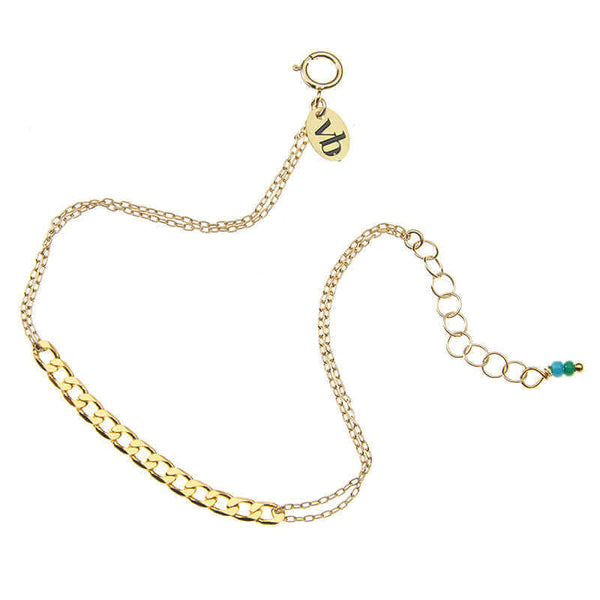 Delicate gold chain bracelet with curb chain detail at center, and tiny blue beads at clasp.