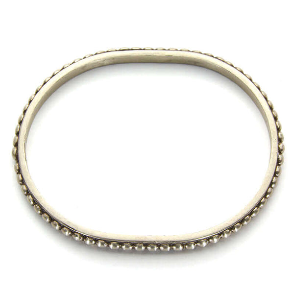 Polished white bronze beaded bangle bracelet, shown from above.