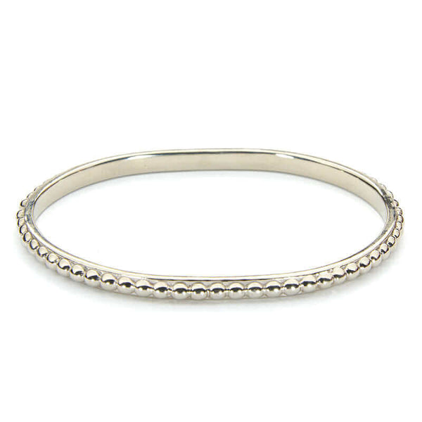 Polished white bronze beaded bangle bracelet.