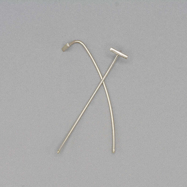 Pair of silver bar threader earrings with wire bar extending down, laying overlapped.