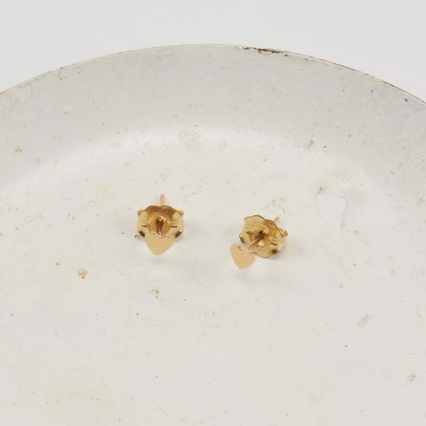 Pair of a Heart Stud Earrings Displayed on a Marble Plate