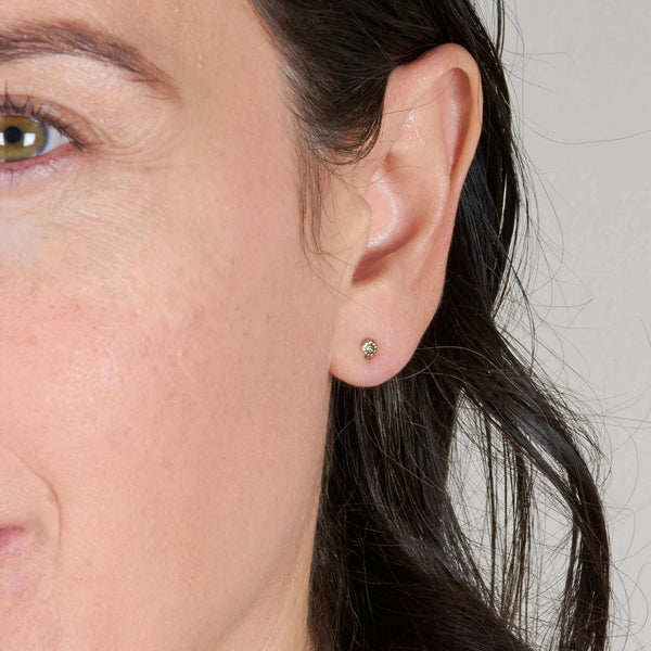 A Woman Wearing Daisy Small Flower Post Earring on Pierced Ear