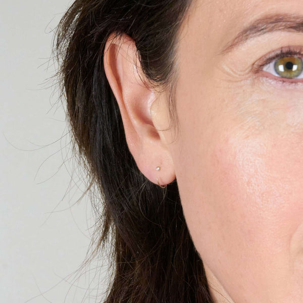 A Woman Wearing Elin Gold Earrings