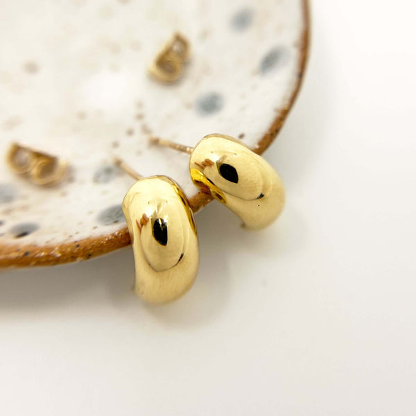 a Pair of aby Semi Hoop Earrings Displayed on a Marble Plate