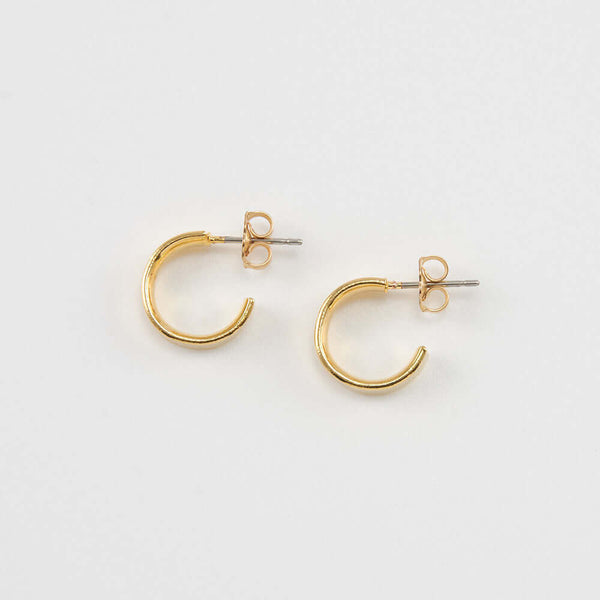 Pair of small gold open hoop earrings on posts.