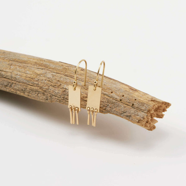 Luisa Large Earrings displayed on driftwood