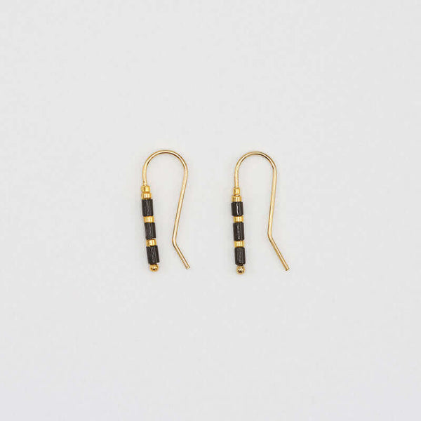 Pair of small gold wire earrings with black and gold beads.