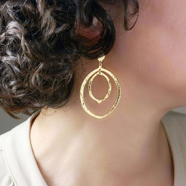 A Woman Wearing Nena Hammered Dangle Earrings