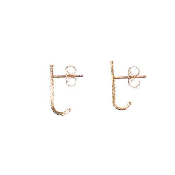 Pair of gold earrings, curved spike with serrations on posts that hooks around earlobe.