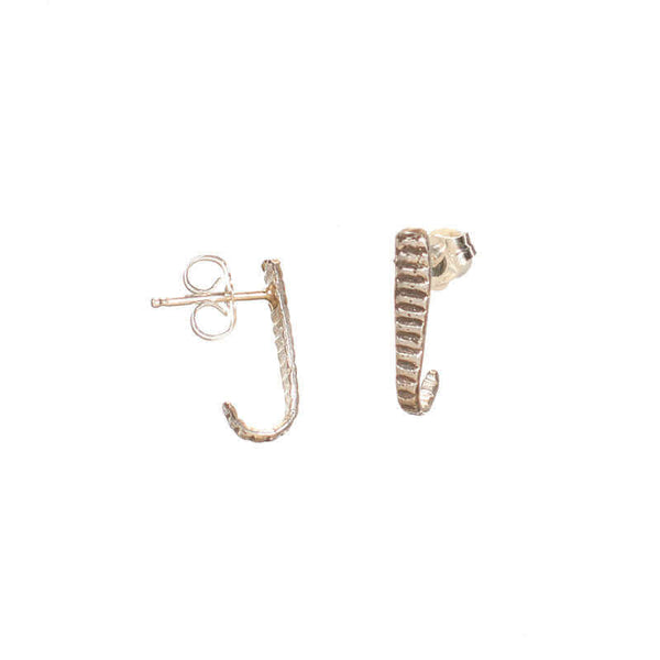 Pair of silver earrings, curved spike with serrations on posts that hooks around earlobe.