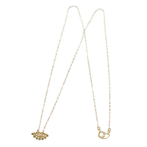 Gold necklace with fan-shaped lace pattern pendant, inset with small diamond.