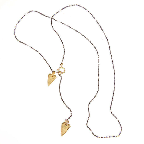 Black chain necklace with brass arrowheads, full length showing clasp.