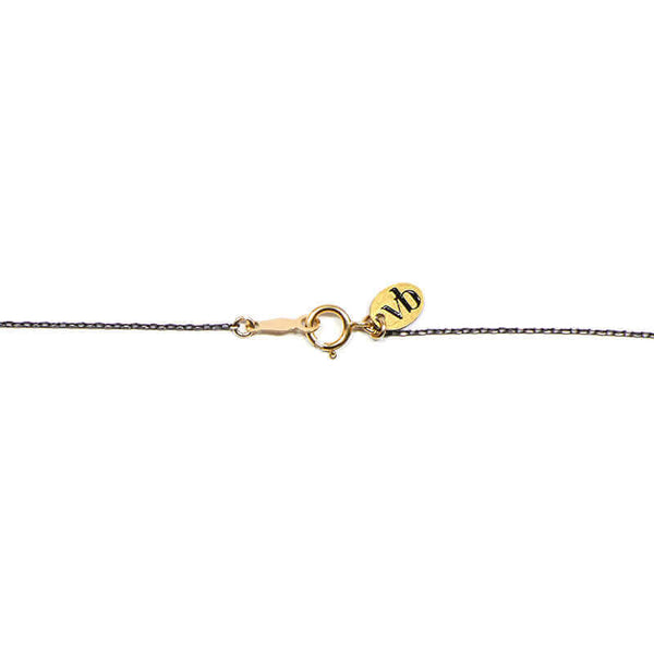 Close-up of necklace with black chain showing clasp detail.