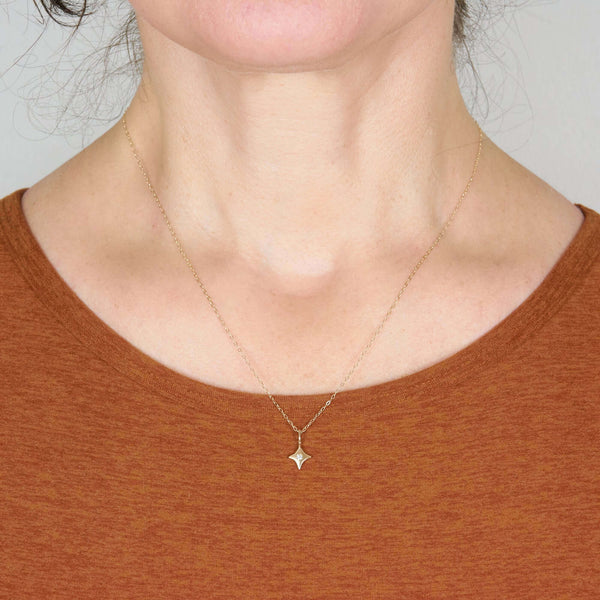 A Woman Wearing Inez Tiny Star Pendant Necklace