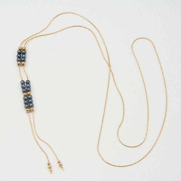 Gold chain necklace with pendant of double rows of dark pearls and gold beads, that slide to adjust length.