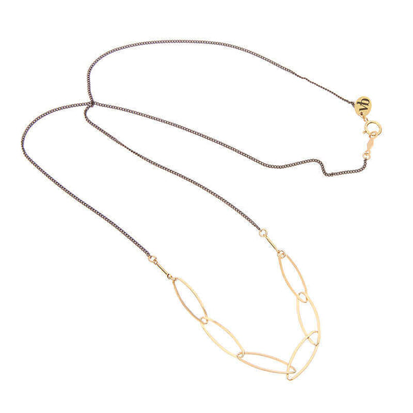 Black oxidized silver necklace with oval gold links on the bottom.