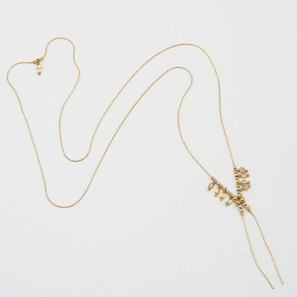 Adjustable delicate gold chain necklace with sliding beads and adjustable end.