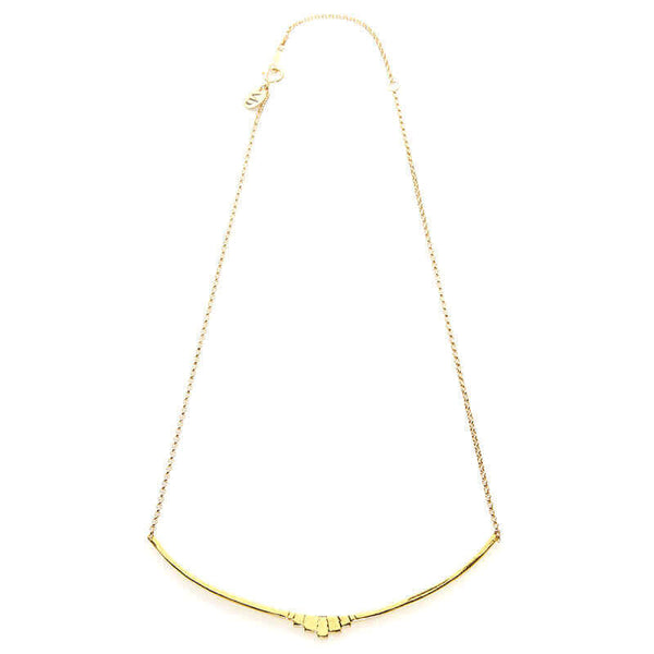 Gold necklace with curved bar pendant with geometric native motif.