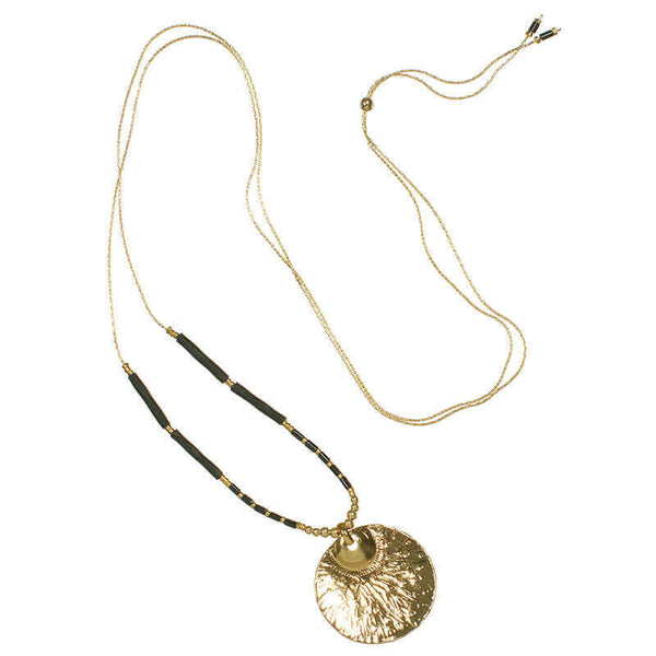 Gold necklace with round medallion and black beads on either side, showing slider clasp.
