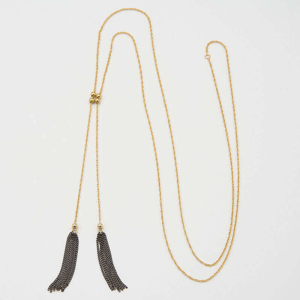 Long gold necklace with double tassels as pendant, with adjustable slider.