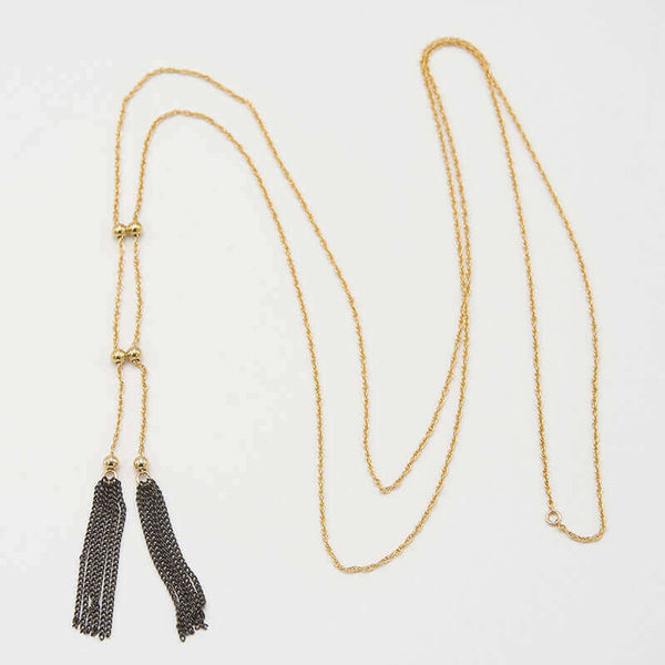 Long gold necklace with double tassels as pendant, with adjustable slider.