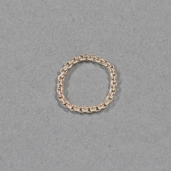 Thick silver chain ring on gray background.