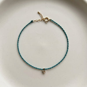 RHODAS FLOWER BRAIDED STRING BRACELET
