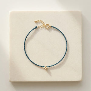 RHODAS FLOWER BRAIDED STRING BRACELET