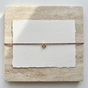 RHODAS FLOWER BRAIDED STRING BRACELET