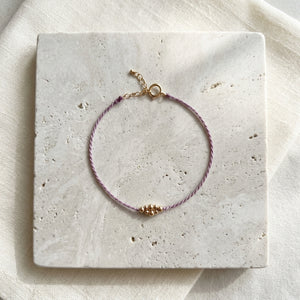 RHODAS BUBBLES BRAIDED STRING BRACELET