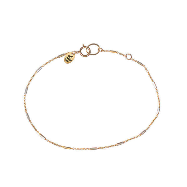 Delicate gold chain bracelet, with silver rectangular bead accents.