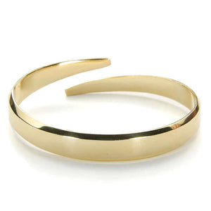 Heavy cuff bracelet with chamfered edges and overlapping ends, in polished brass.