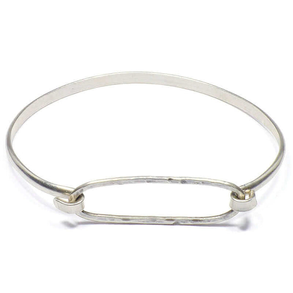 Simple bangle bracelet of silver hammered oval on silver cuff.