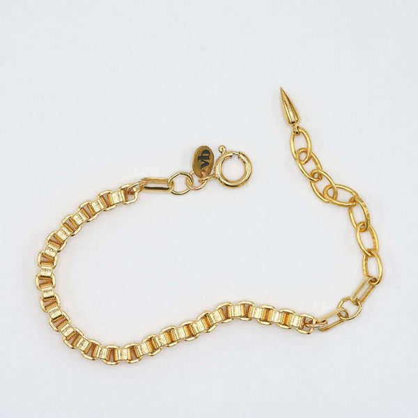 Chunky gold box chain bracelet, with oval links and spike at clasp.