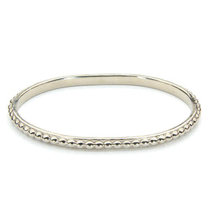 Polished white bronze beaded bangle bracelet.
