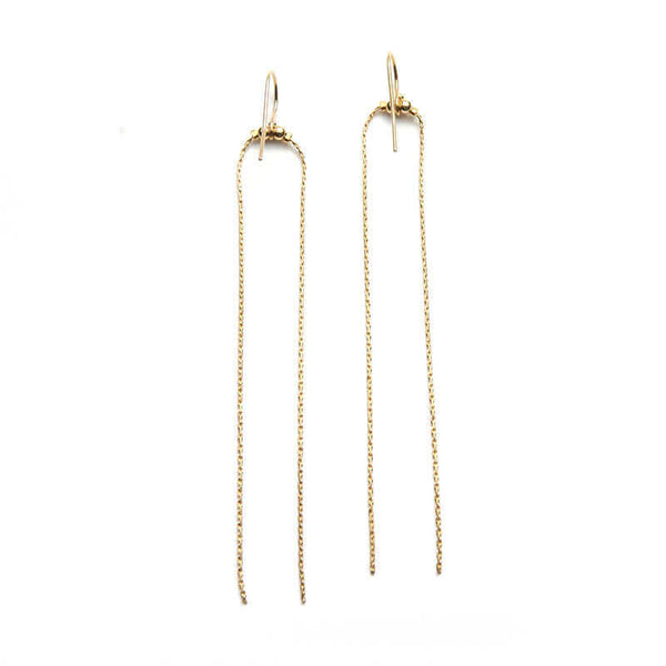 Pair of gold earrings with two delicate chains that hang down.