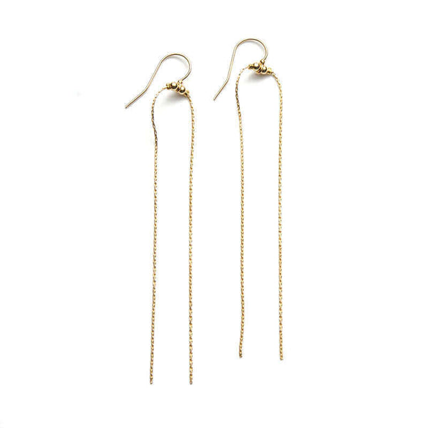 Pair of gold earrings with two delicate chains that hang down with earwire to the side.