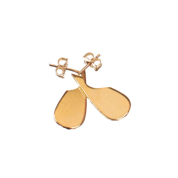 Pair of flat gold earrings on a post, with unique teardrop shape, on laid overlapping.