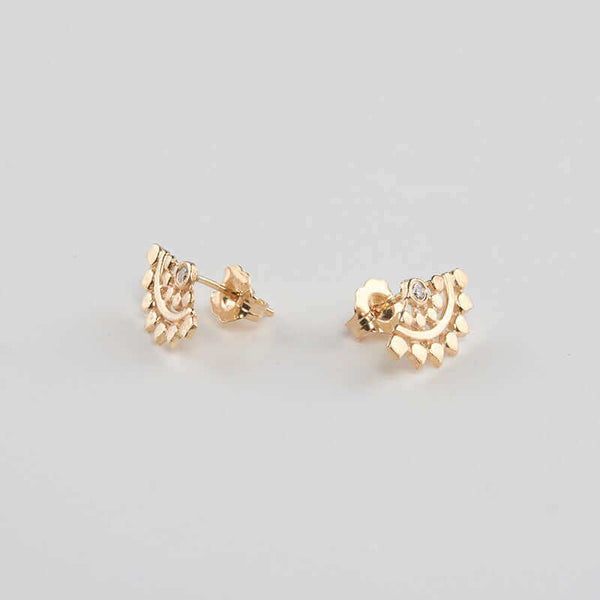 Pair of fan-shaped gold earrings with lace pattern, inset with small diamond, shown facing out.