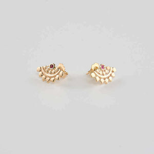 Pair of fan-shaped gold earrings with lace pattern, inset with small ruby, shown facing in.