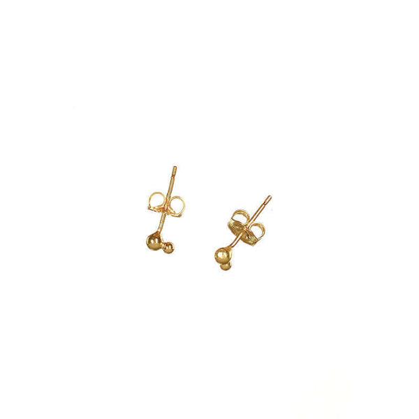 Small gold earrings with two gold stacked beads on a post.