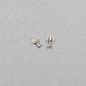 Small silver earrings with two gold stacked beads on a post.