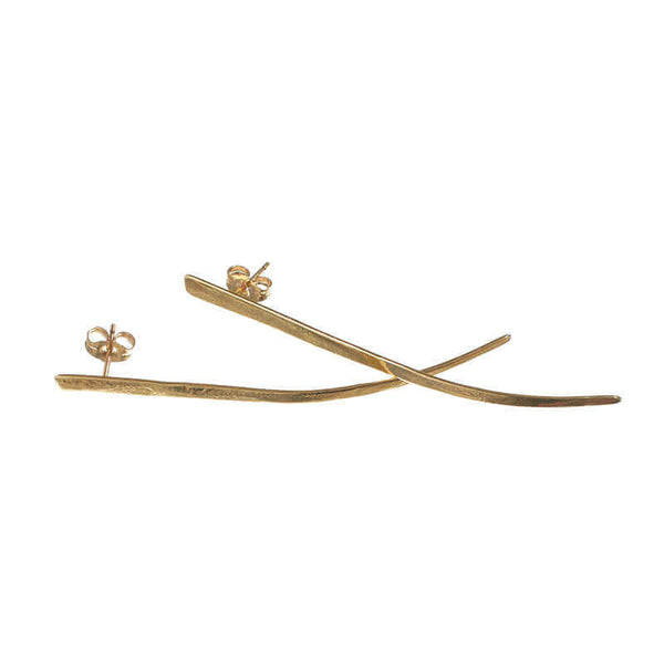 Pair of gold spike earrings, flat spike with a slight curve at tip, laid overlapping.