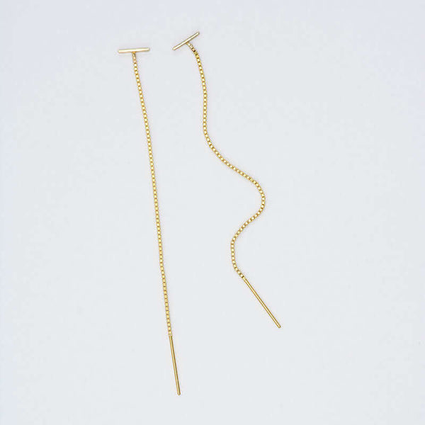 Pair of gold threader earrings, small bar with fine gold chain ending in bar, shown at angle.