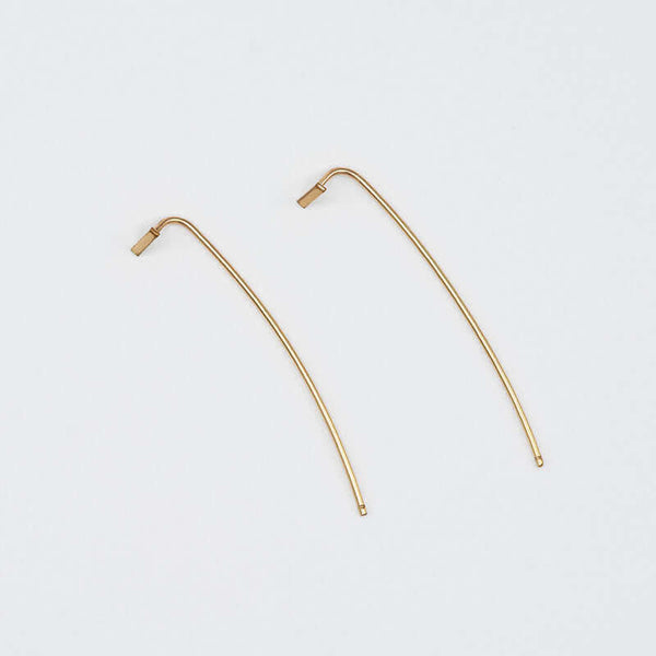 Pair of gold bar threader earrings with wire bar extending down.