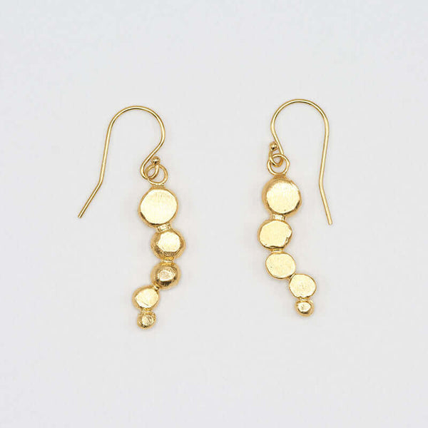 Pair of gold earrings with flattened beads of descending size.