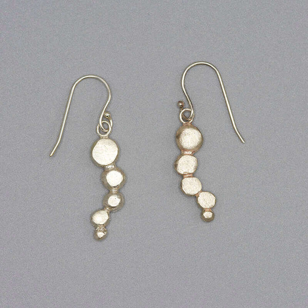 Pair of silver earrings with flattened beads of descending size.